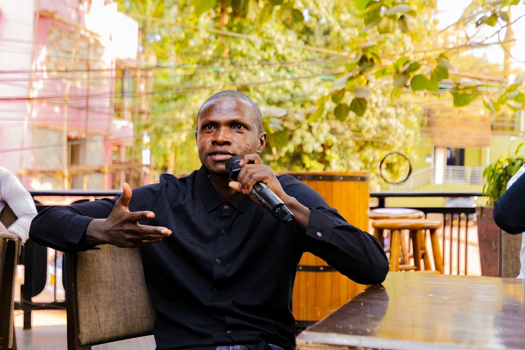 Speaker holding microphone during a community conversation